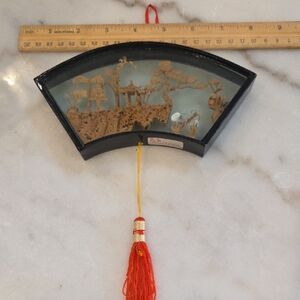 Decorative Fan-Shaped Wall Art with Red Tassel